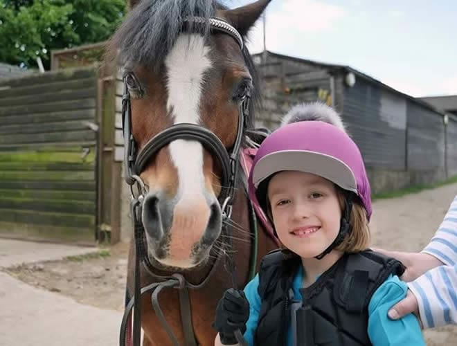 Imogen with her new helmet and cover, and her best friend! - Cerebra